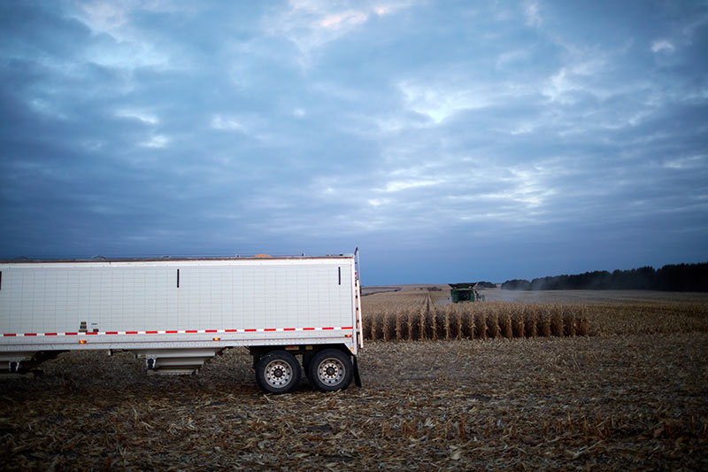 A picture of a semi trailer in a field.